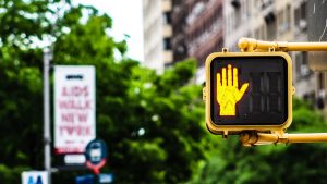 Street sign displaying a yellow hand 