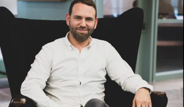 Picture of Jason Foster seating on an armchair