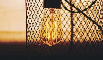 Light bulb in front of wire fence